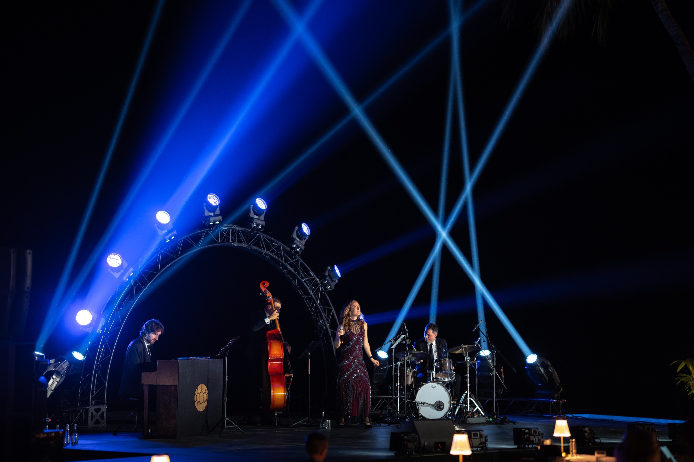 Jazz band on stage under blue light beams during a jazz night at a private island in the Maldives