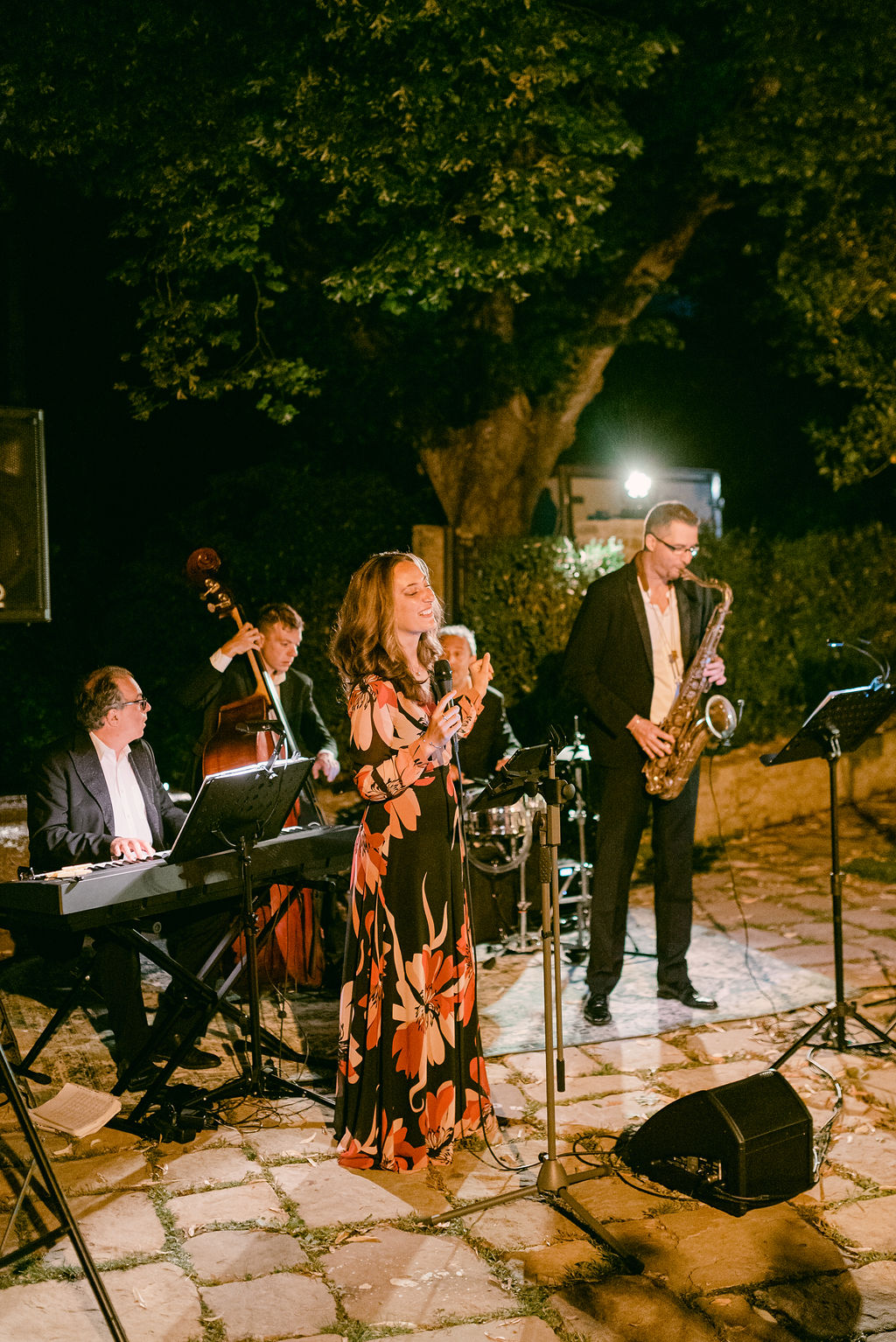 Italian jazz quartet performing outdoors at night during a private party