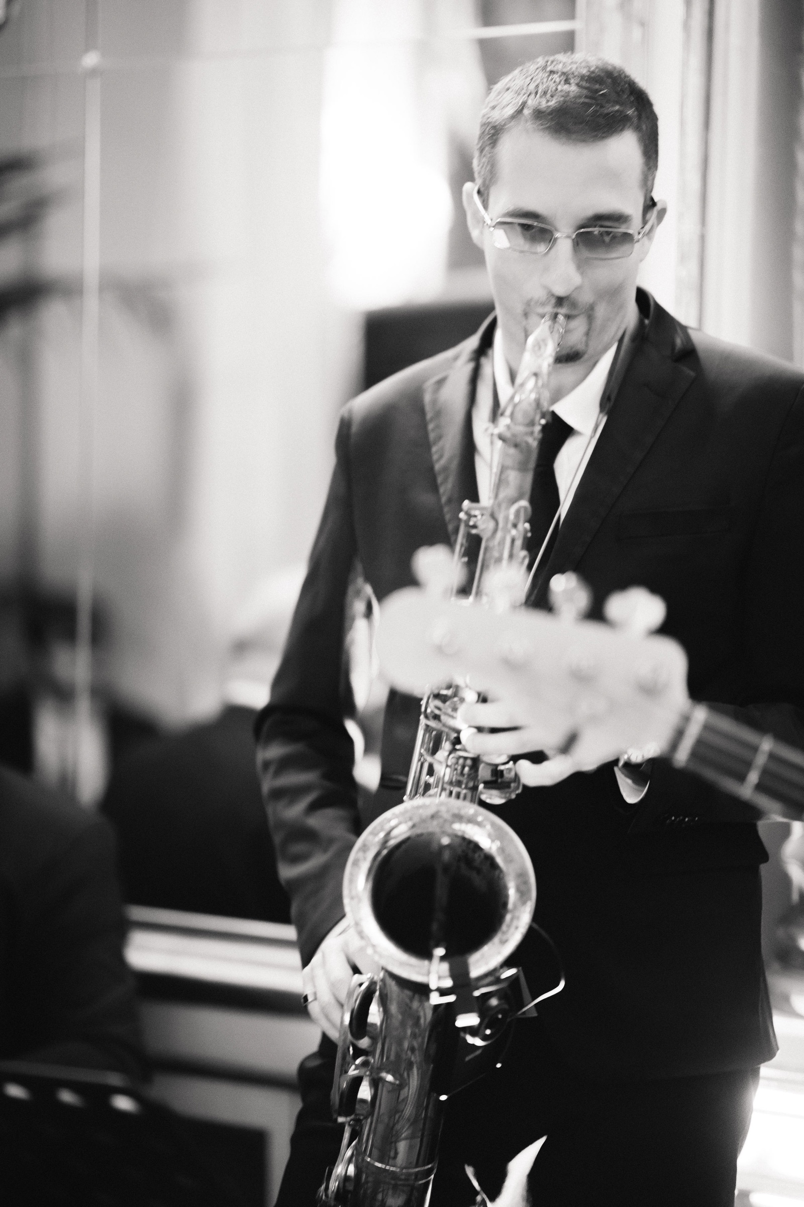 Black and white close-up of a saxophonist playing at a wedding in Florence